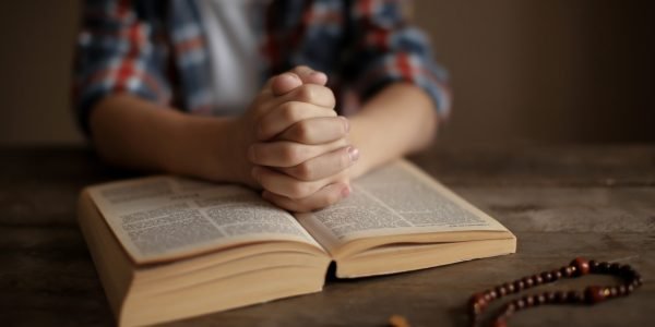 KYIV UKRAINE JANUARY 03 2018 Little boy reading Bible at table